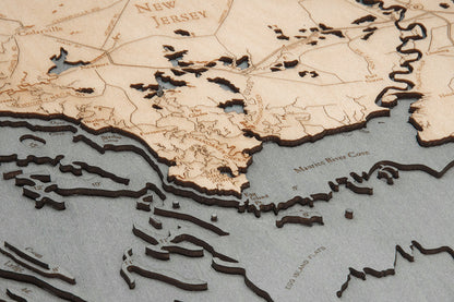Delaware Bay wood chart map made using a darker green and natural colored wood on black background up close