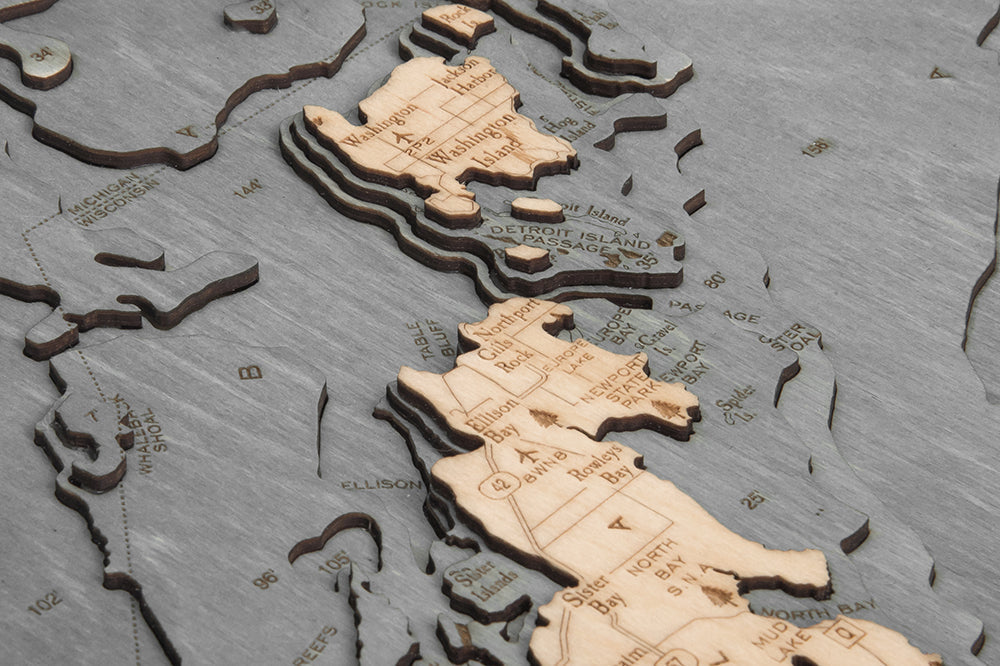 Green Bay/Door County, Wisconsin wood chart map made using a darker green and natural colored wood up close