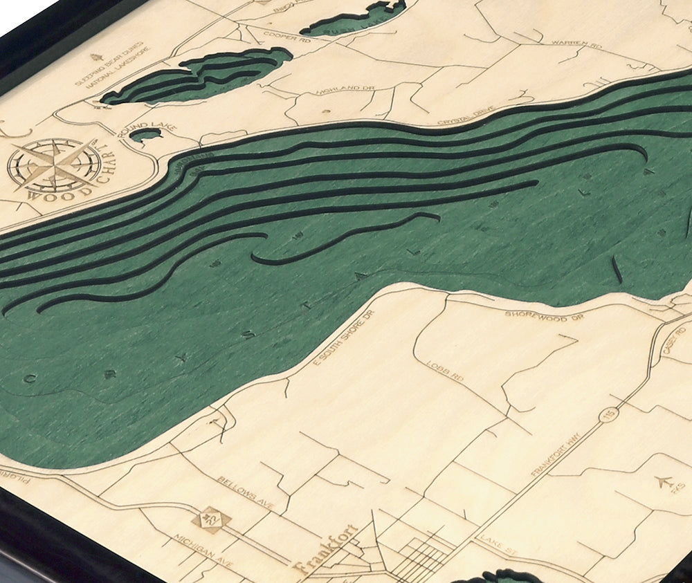 Crystal Lake, Michigan wood chart map made using green and natural colored wood on white background with dark frame up close