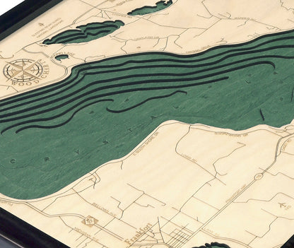 Crystal Lake, Michigan wood chart map made using green and natural colored wood on white background with dark frame up close
