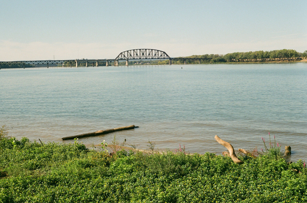 The Ohio River shoreline at Louisville, Kentucky with a bridge in the distance