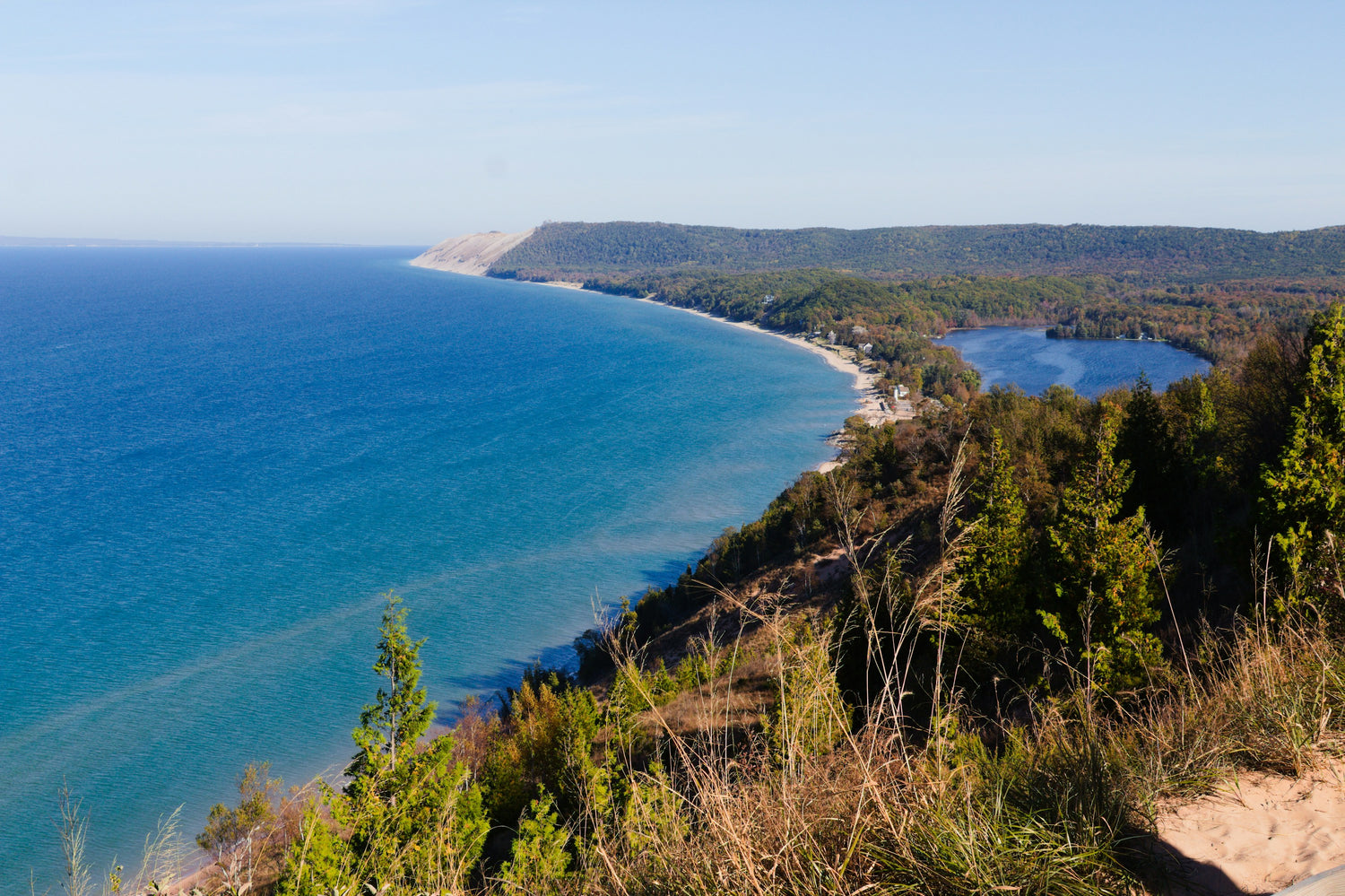 View from a high dune bluff over the blue water of Lake Michigan