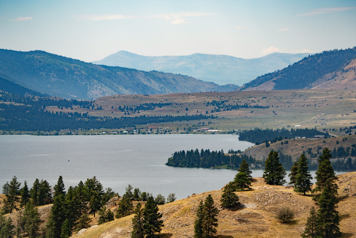 Flathead Lake in Montana ringed by pine-covered hills and distant mountains