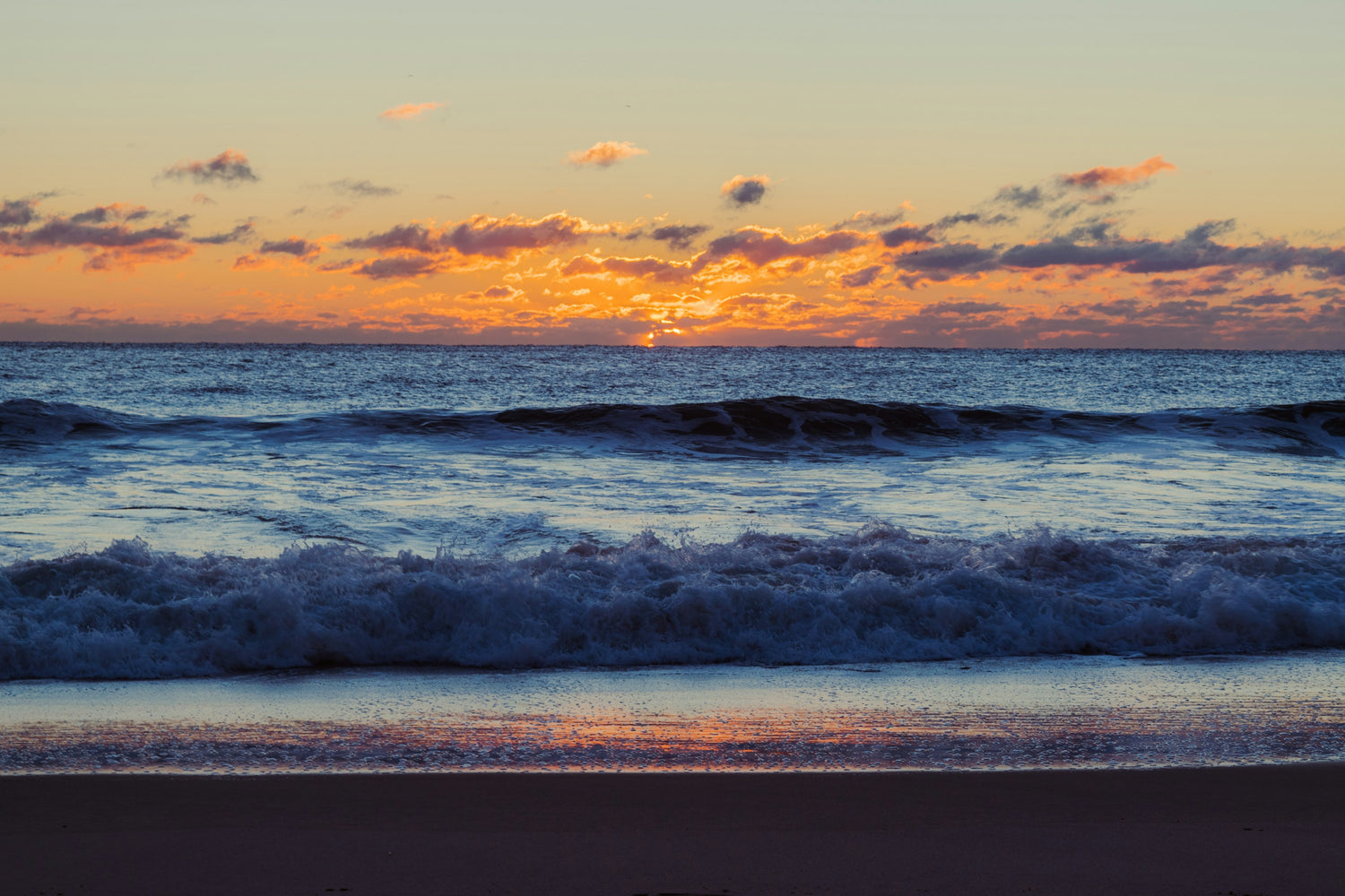 Sunrise light over breaking waves on the Jersey Shore at Bradley Beach, New Jersey
