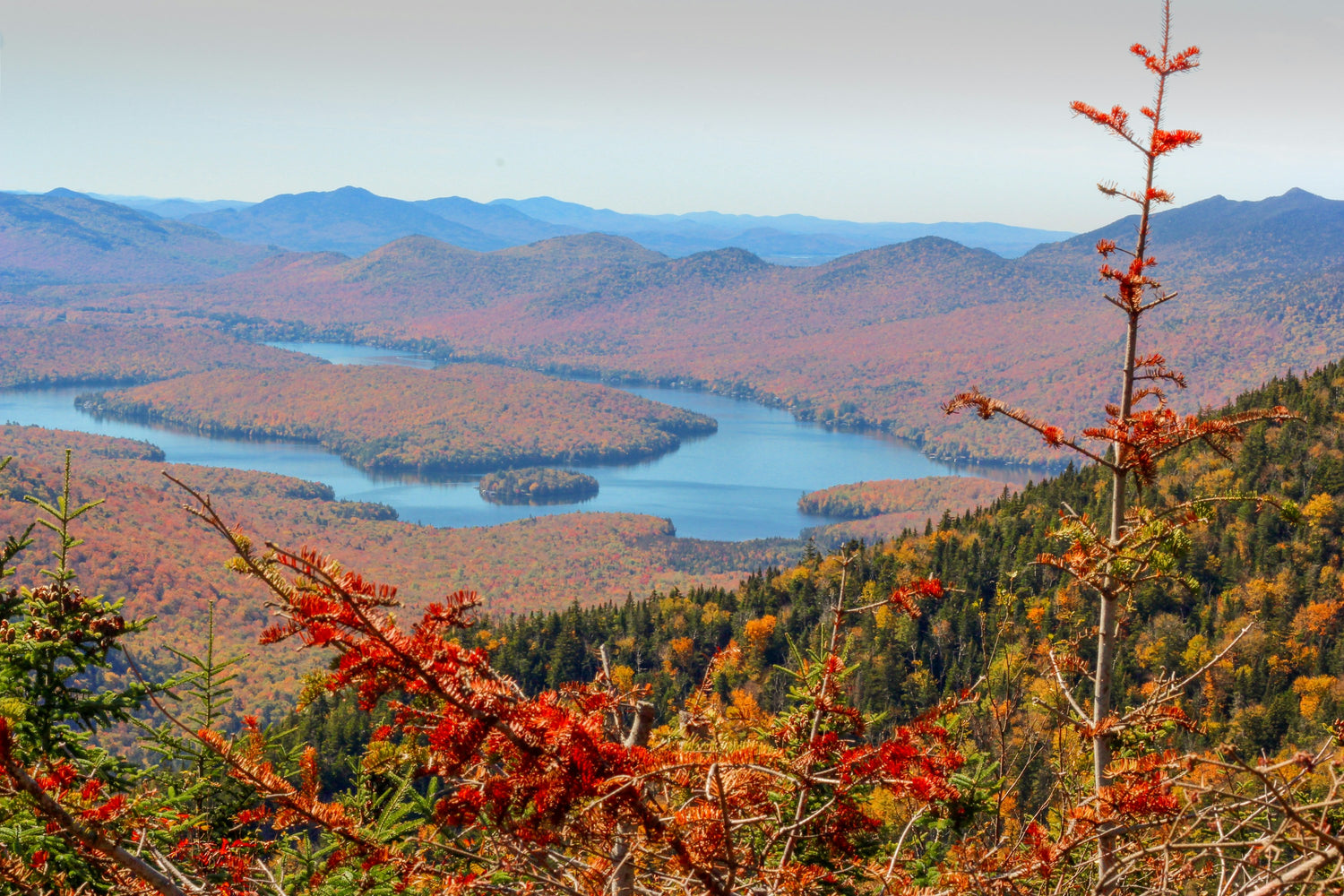Autumn color across the Adirondack Mountains of New York with lakes below