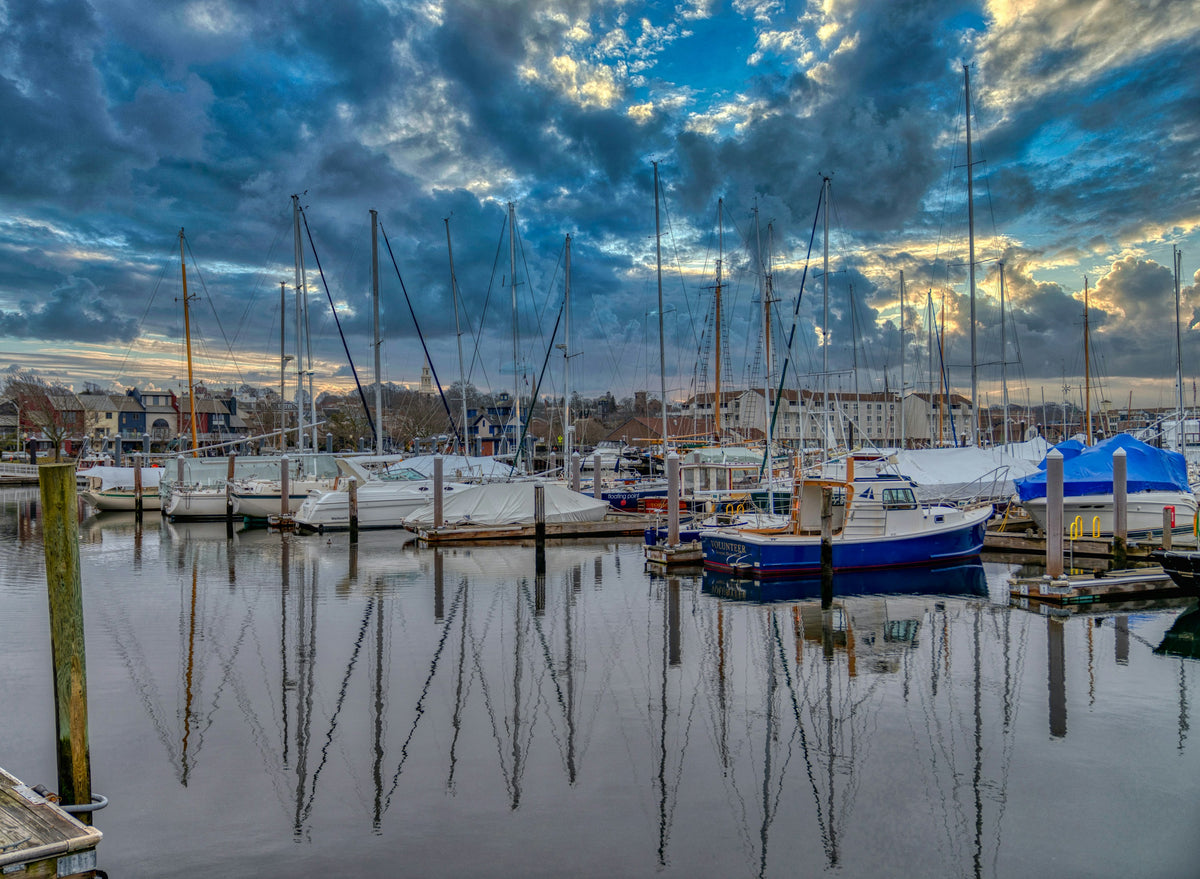 Sailboats and small craft moored in Newport Harbor, Rhode Island under a cloudy sky